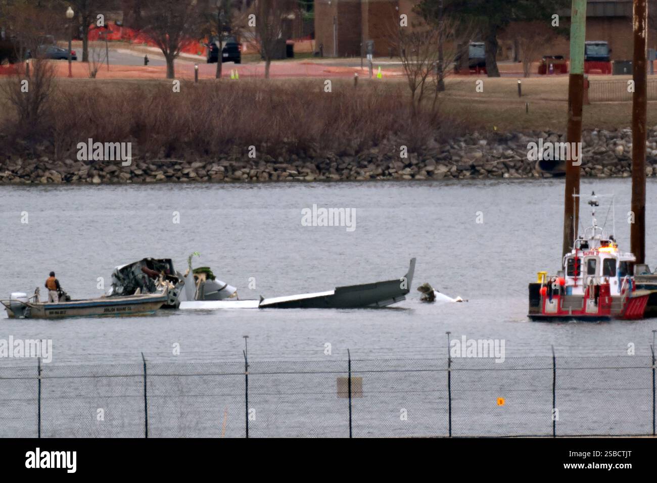 Rescue and salvage crews work near the wreckage of an American Airlines ...