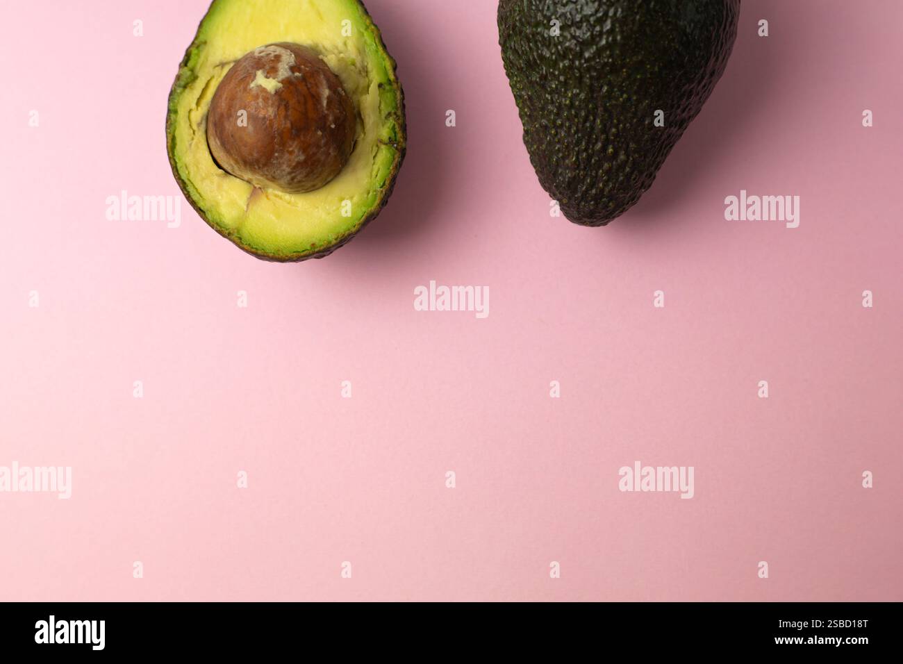half of ripe avocado and whole fruit, healthy food Stock Photo - Alamy