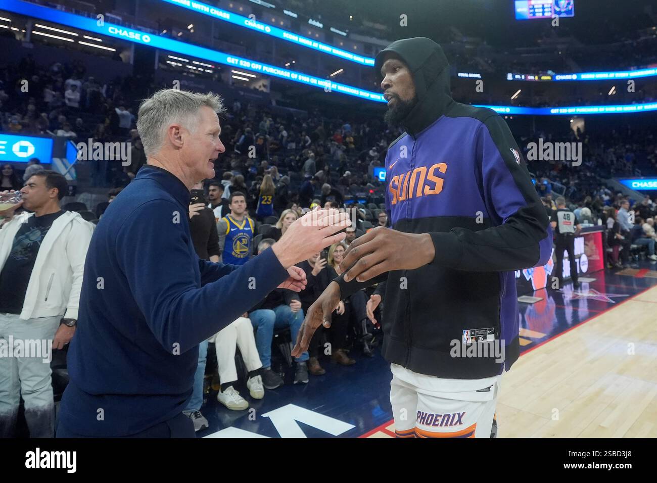 Golden State Warriors head coach Steve Kerr, left, greets Phoenix Suns