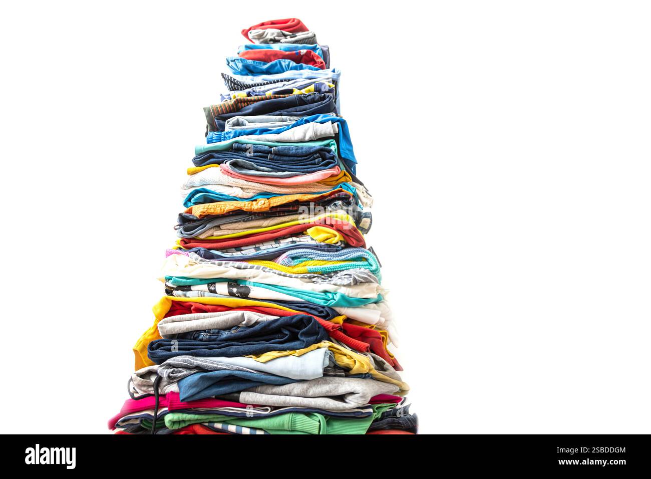 A very tall stack of folded colored clothes for charity, washing ...