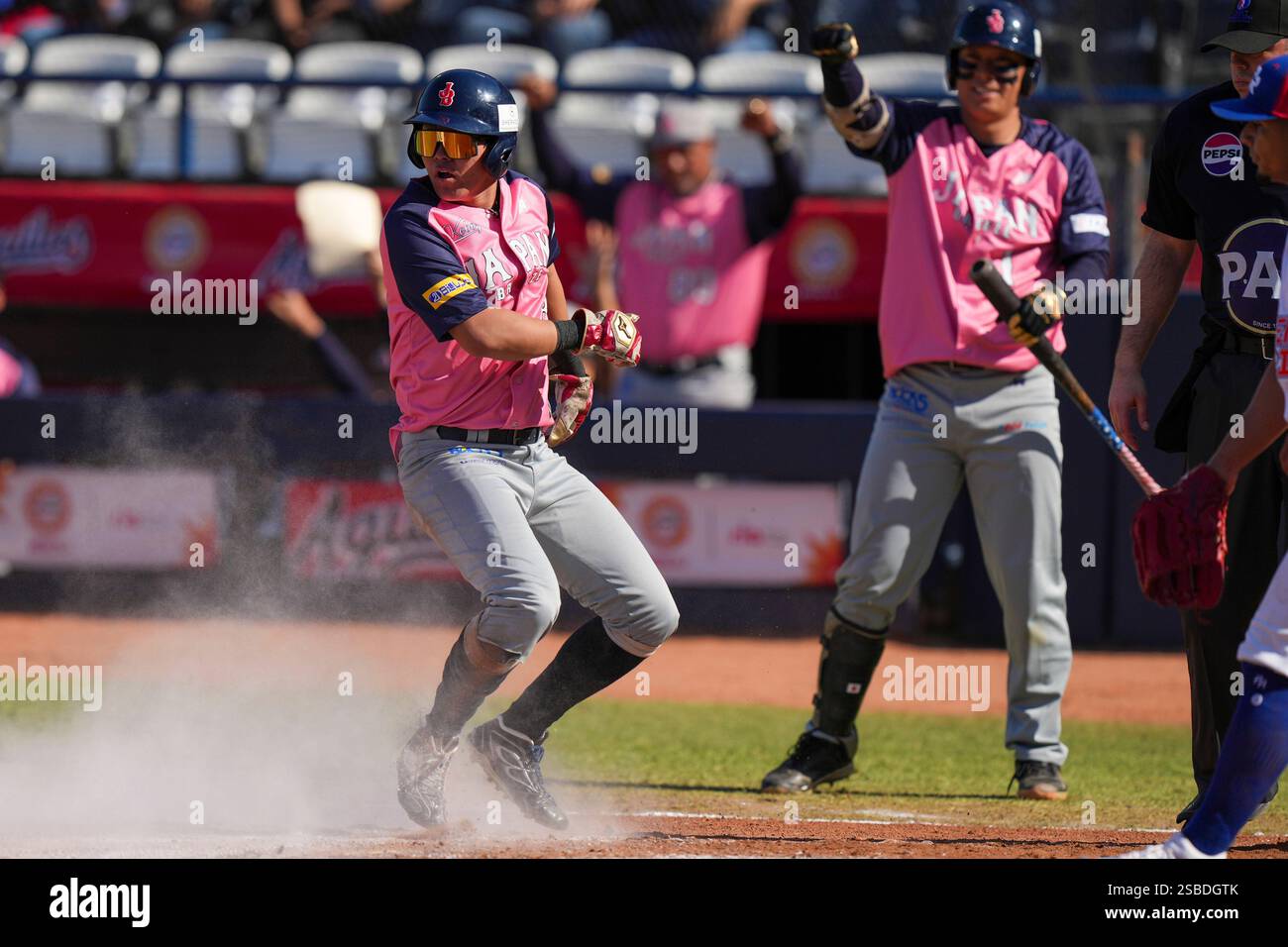 Japan's Takeru Ohashi scores a run against Puerto Rico during a