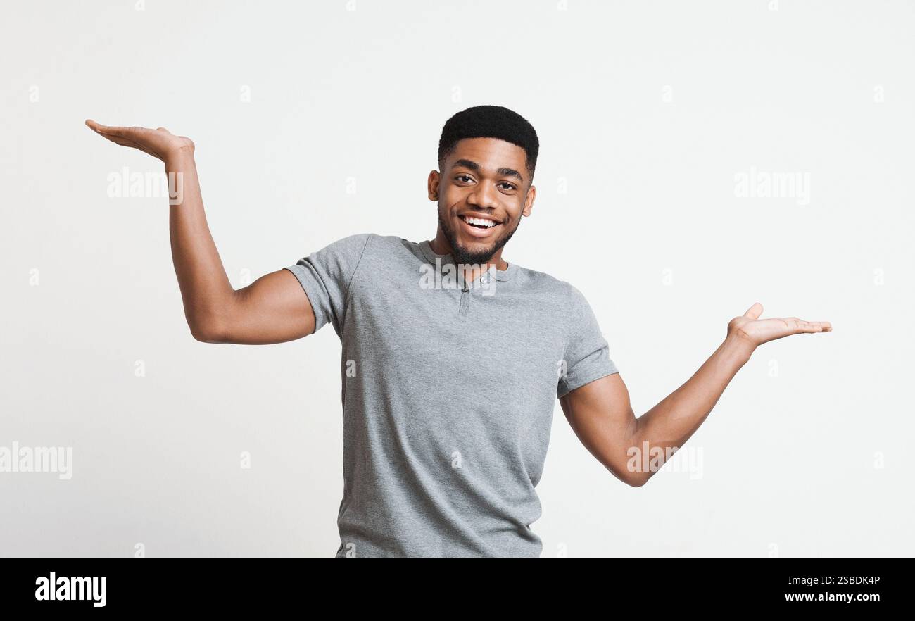 Young black man making scale with his hands Stock Photo - Alamy