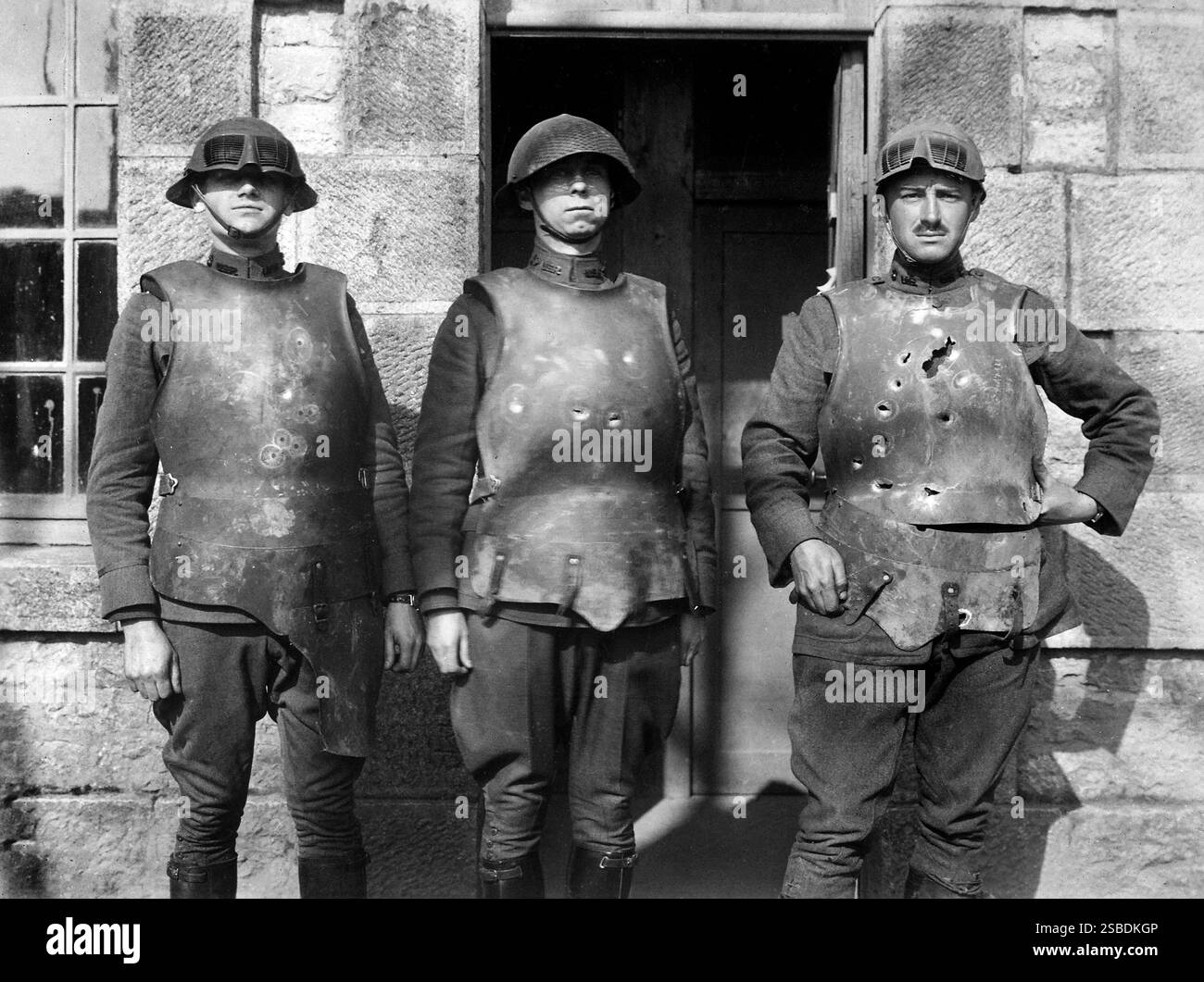 Three U.S. military personnel exhibiting effect of pistol, rifle and machine gun fire on heavyweight body armor, a result of testing conducted by the Army Ordnance Department, Fort de la Peigney, Langres, France, U.S. Army Signal Corps, 1918 Stock Photo