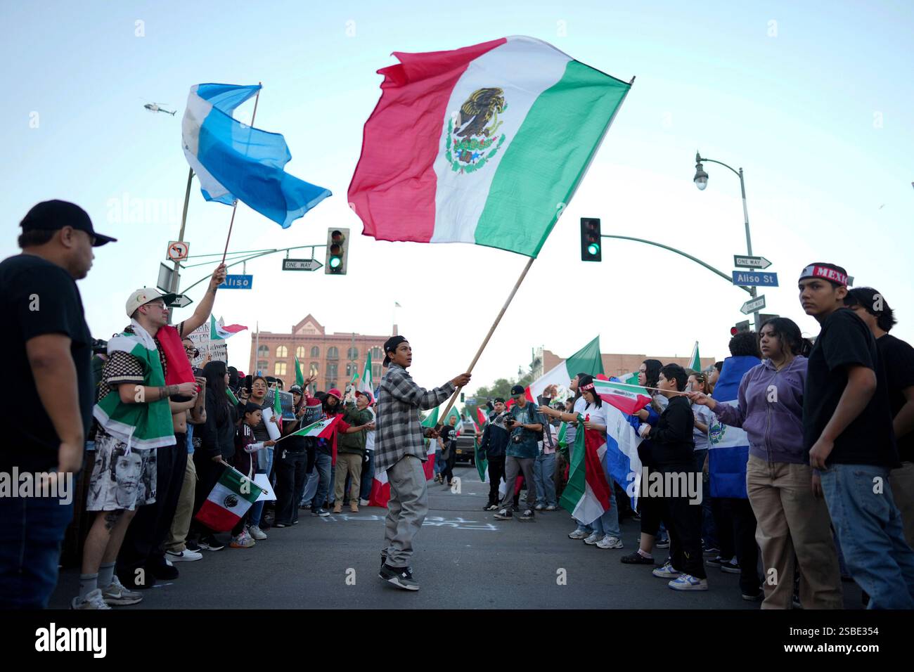 Demonstrators wave flags during a protest calling for immigration ...