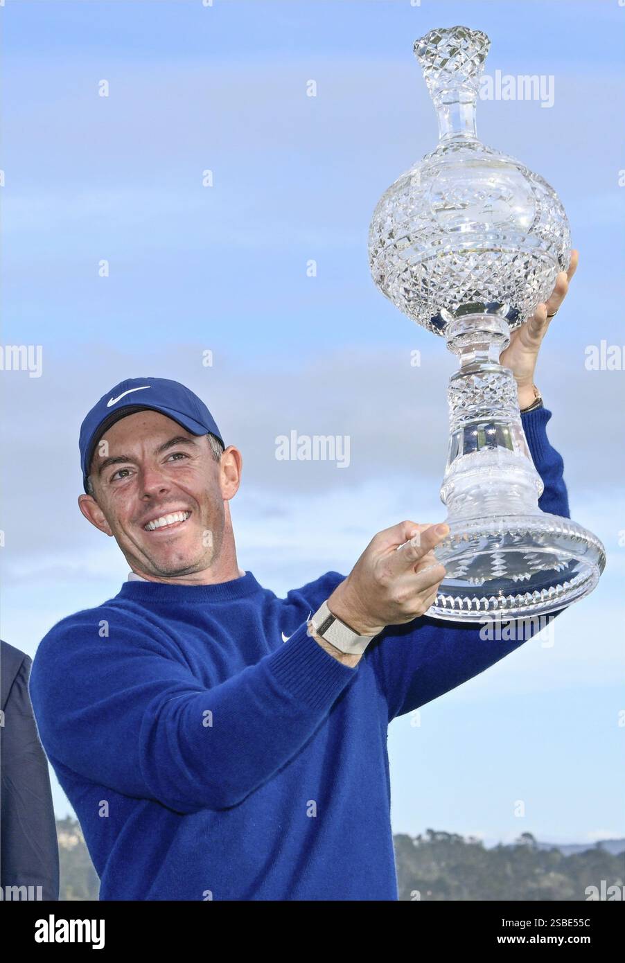 Rory Mcllroy of Britain raises the victor's trophy at the AT&T Pebble