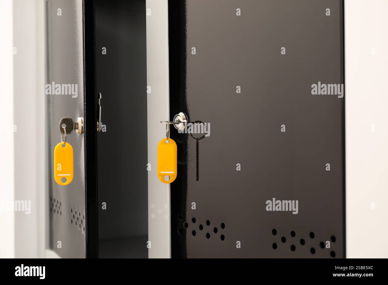 Modern lockers with bright keys indoors, closeup Stock Photo