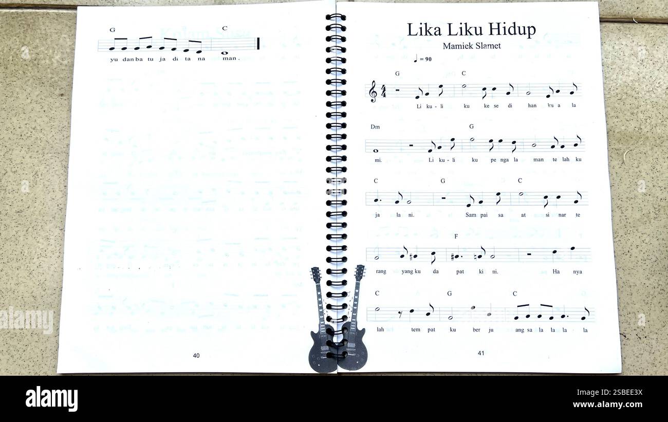 Handwritten Music Notebook with Musical Notation, Chords and Song Lyrics Stock Photo