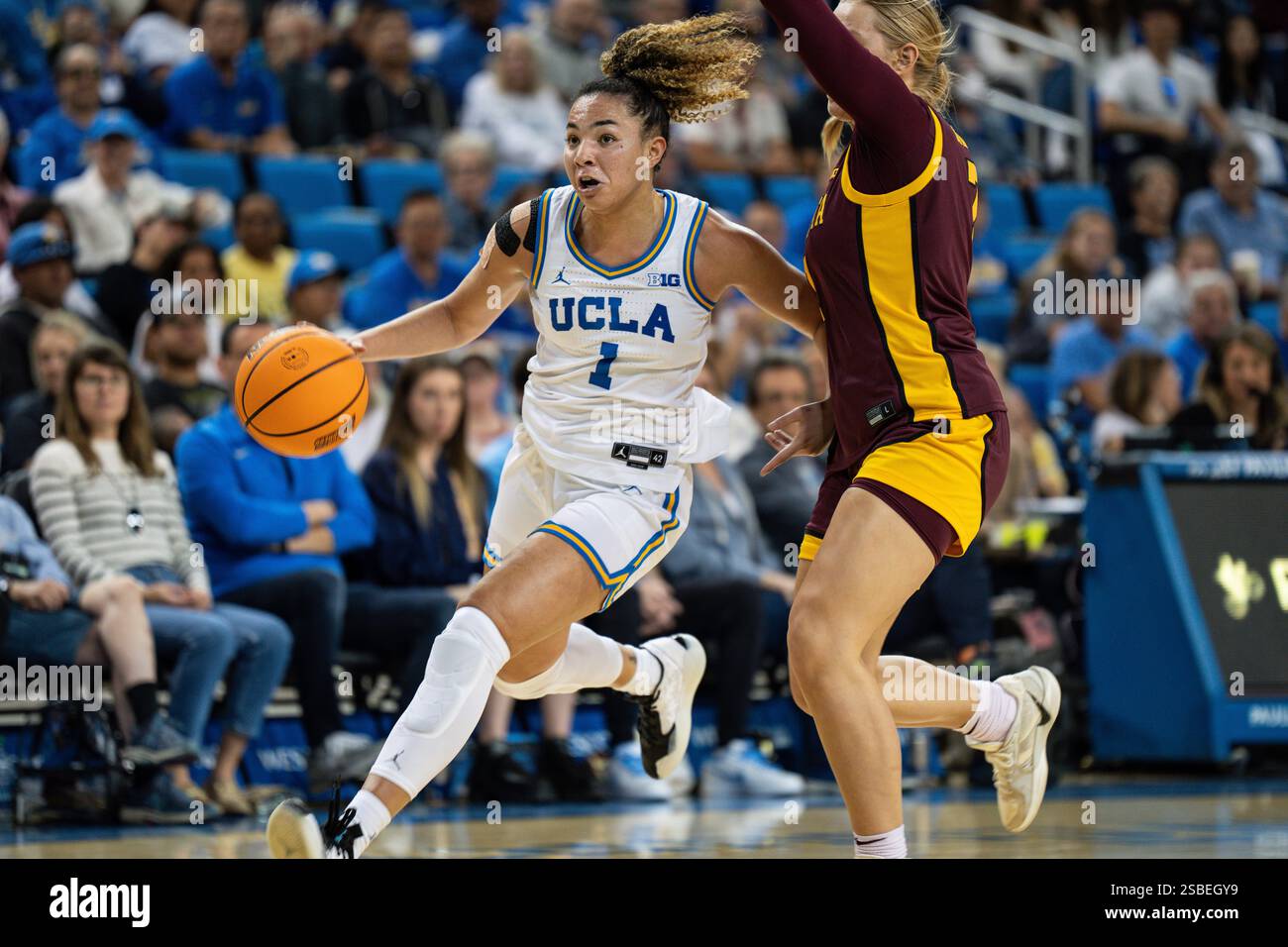 UCLA Bruins guard Kiki Rice (1) is defended by Minnesota Golden Gophers ...