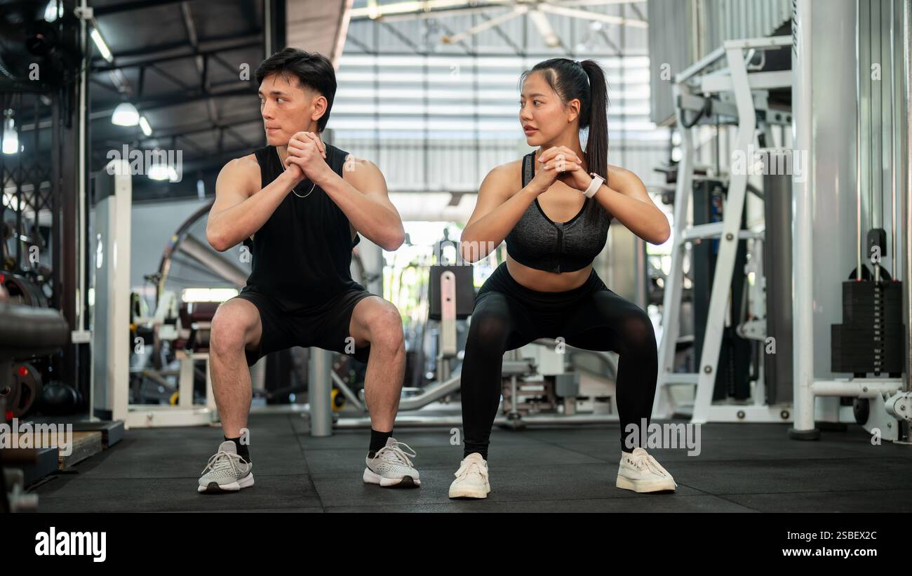 A sporty, athletic Asian couple in sportswear is training together in ...