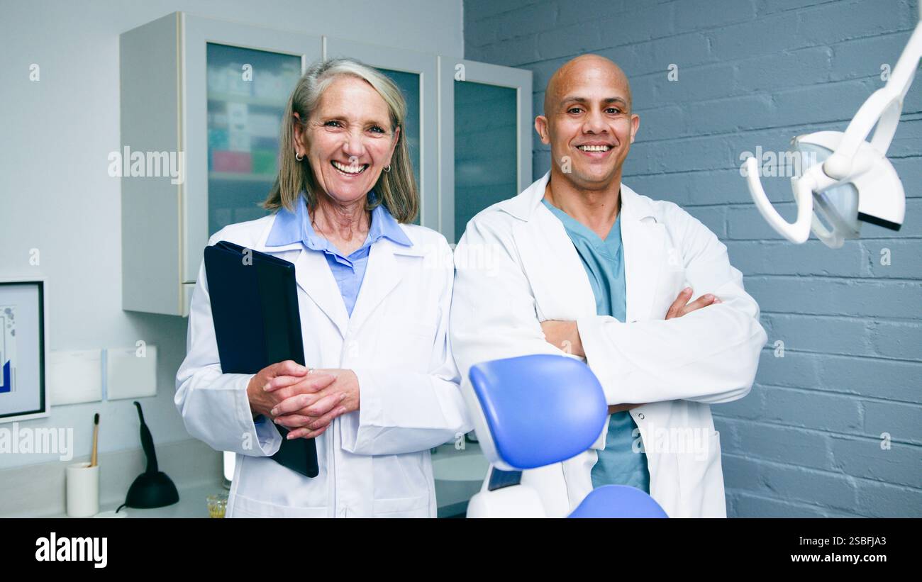Two Confident Dentists Smiling in their Modern Clinic Stock Photo