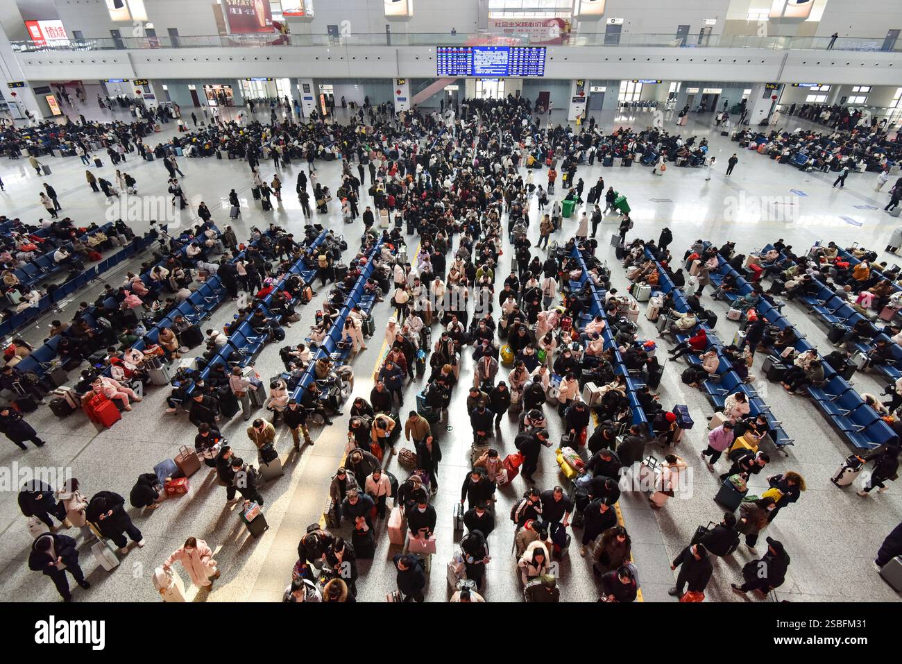 Passengers wait for a ride at the waiting hall of Fuyang West Railway