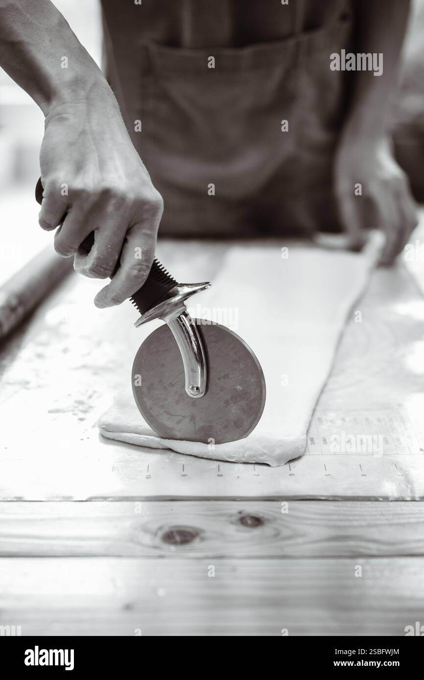 Artisan Baker Cuts Pastry Dough Stock Photo