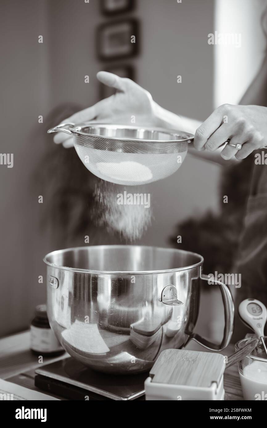 Artisan Baker Sieving Flour for Making Bread Stock Photo