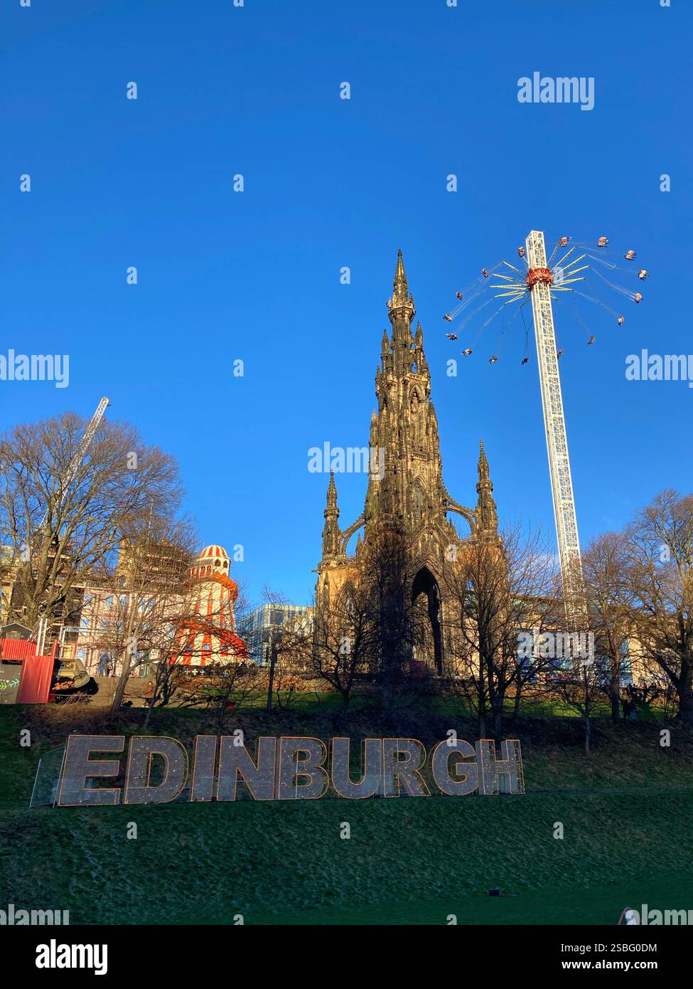 Christmas festivities in Princes Street Gardens with the Star Flyer ride and Scott monument, Edinburgh, Scotland - Smartphone Captured Stock Image