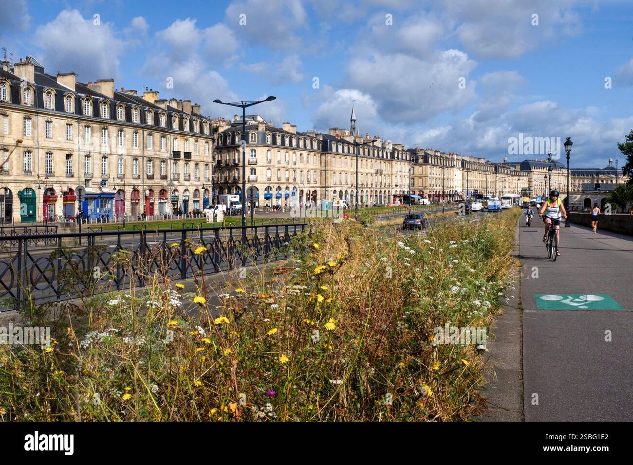Bordeaux (south-western France): the quays, lanes along the Garonne river, with view of building facades, a cycle lane and flowerbeds Stock Photo