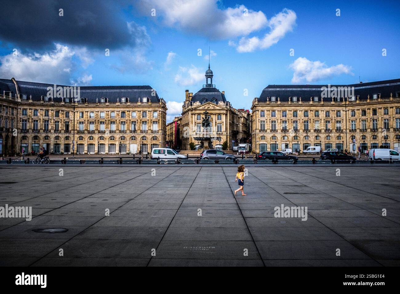 Bordeaux (south-western France): child playing on the ornamental pond and view of building facades in “place de la Bourse” square Stock Photo