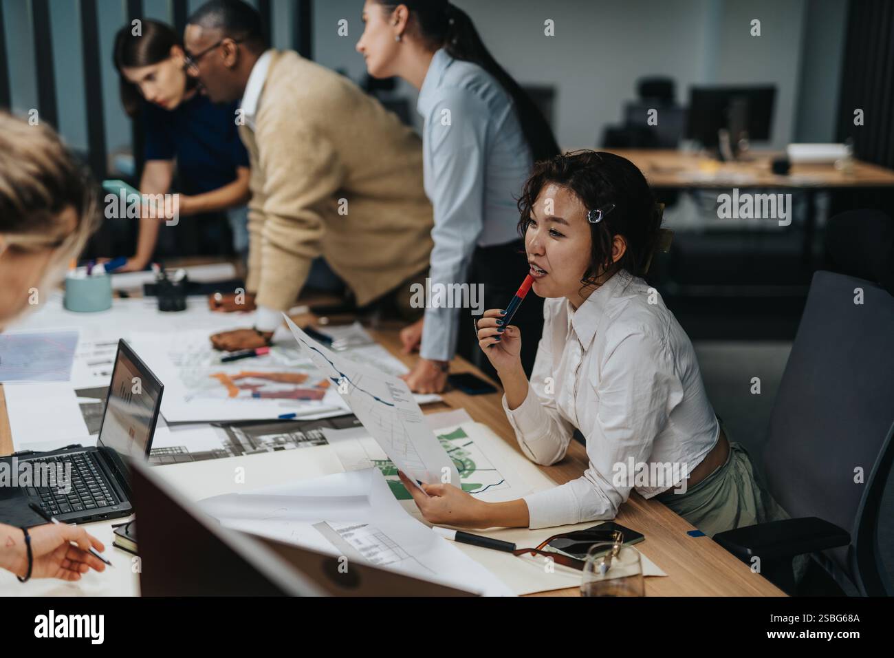 Multiracial business team collaborating on an innovative project in ...