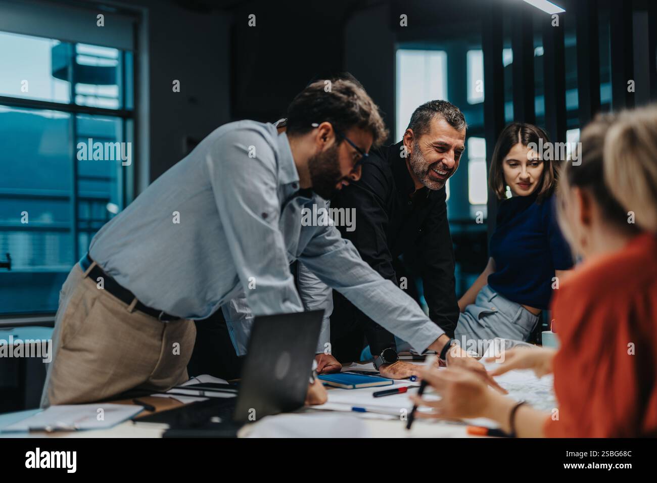 Multiracial team collaborating on a creative business project Stock Photo