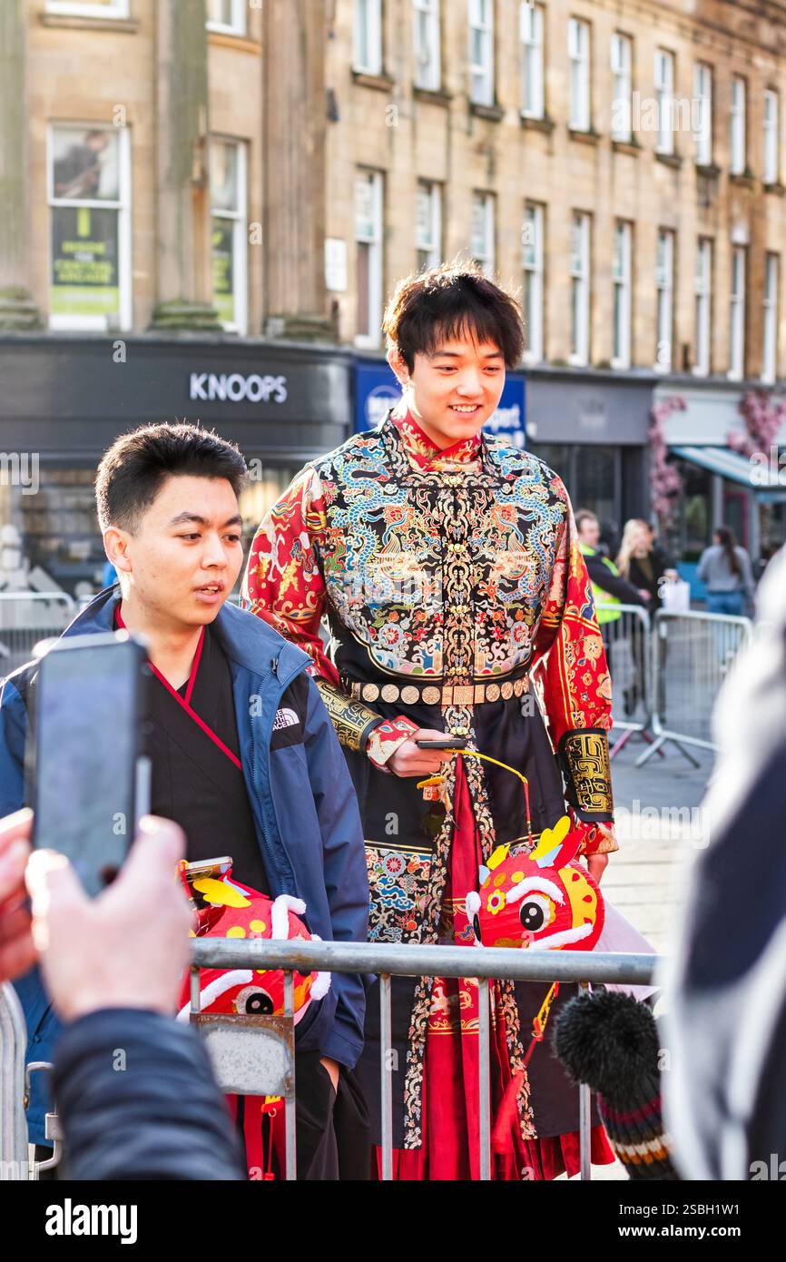 two young asian men in traditional dress at Chinese new year parade CNY