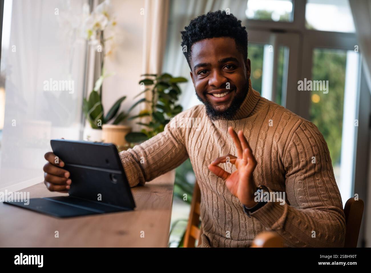 Freelancer using digital tablet to communicate online. Stock Photo