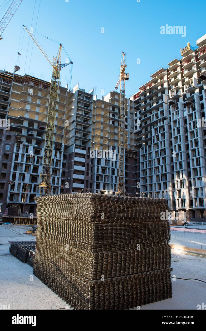 Ongoing construction of modern high-rise apartments with cranes, steel ...