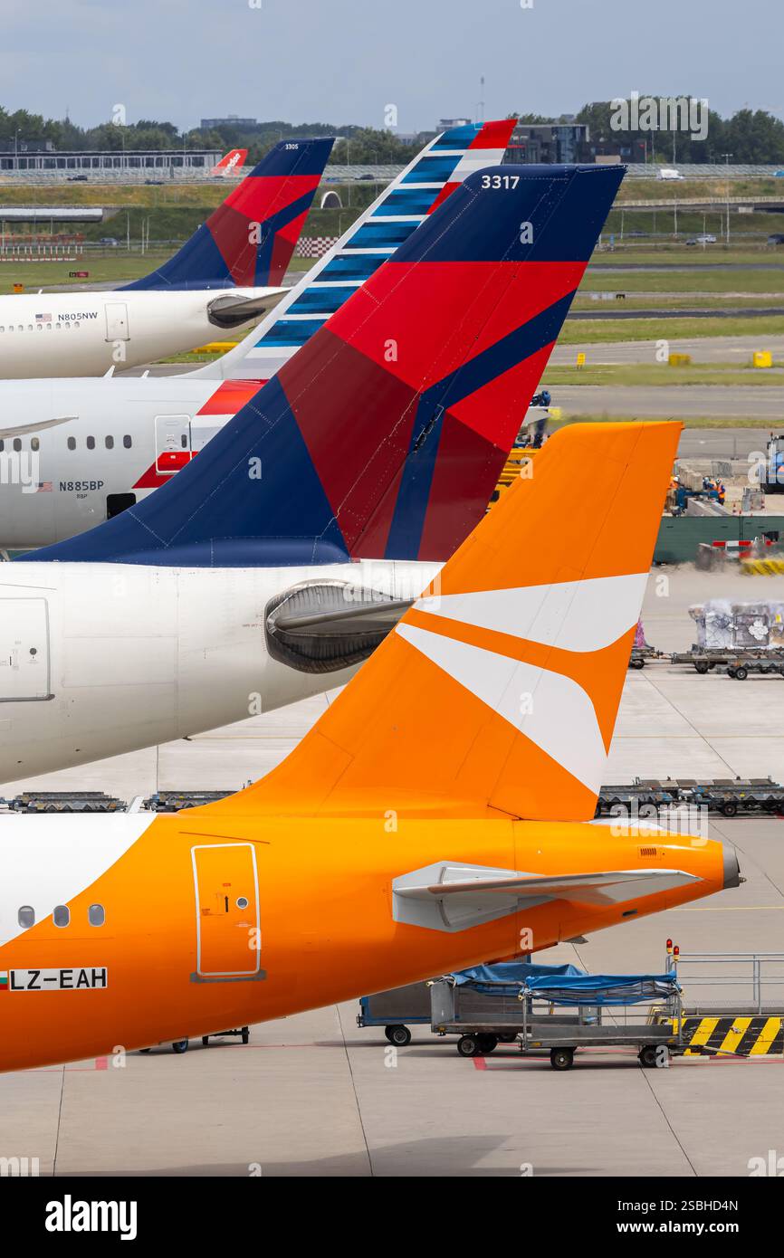 Amsterdam, Netherlands - July 1, 2024: Airplane tails at Amsterdam Airport in the Netherlands. Stock Photo