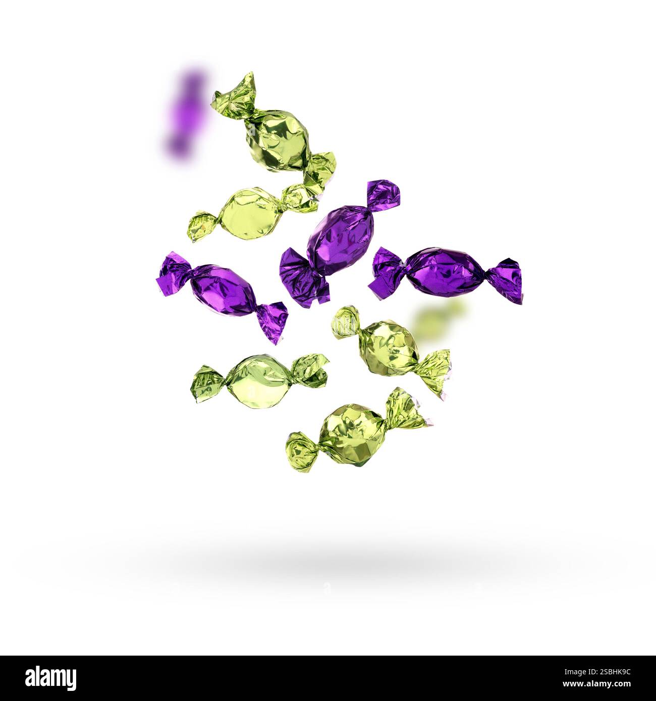 Candies in bright wrappers falling on white background Stock Photo