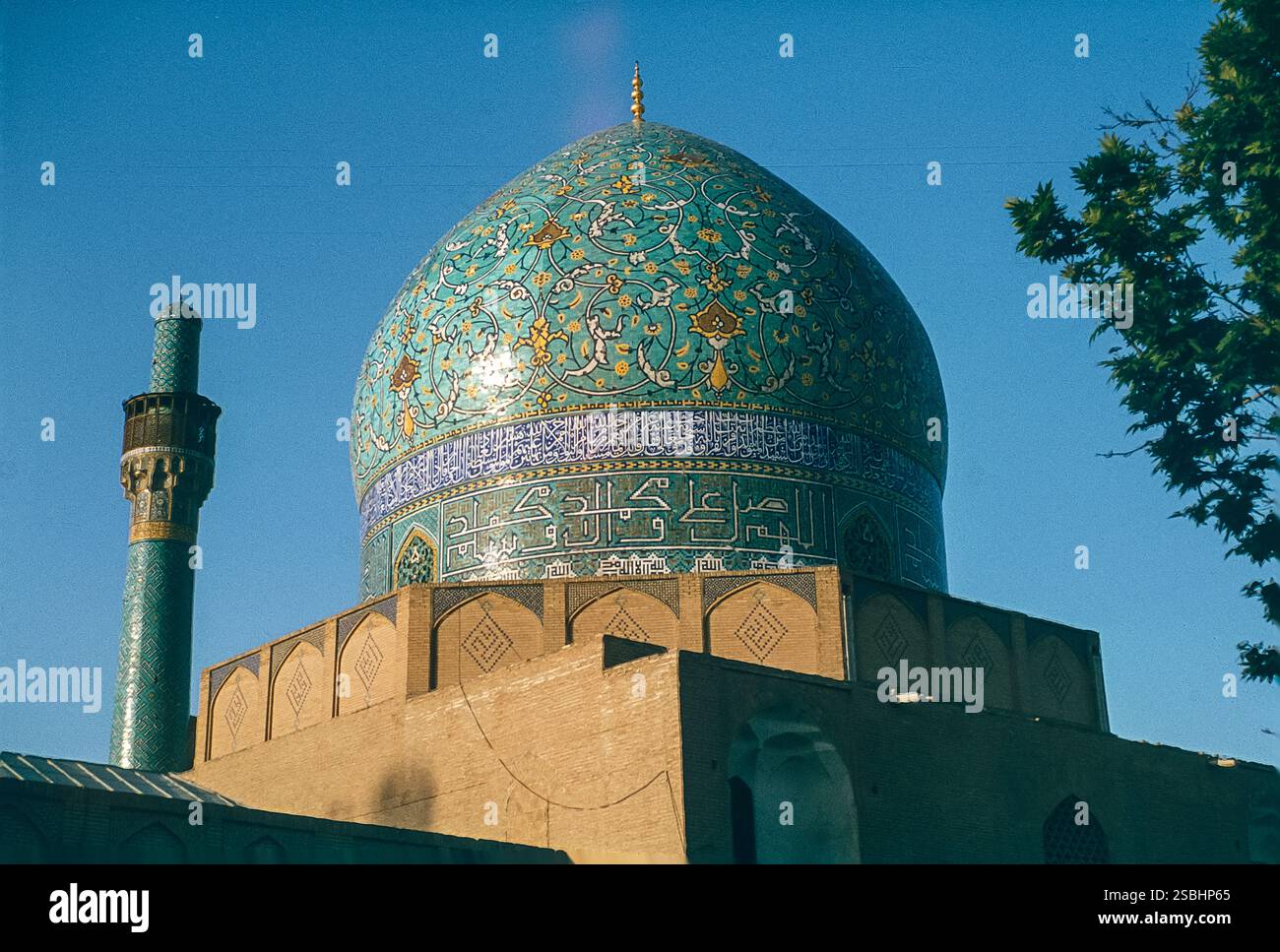 The image is of the Islamic dome and minaret of the Madrese Madar-I ...