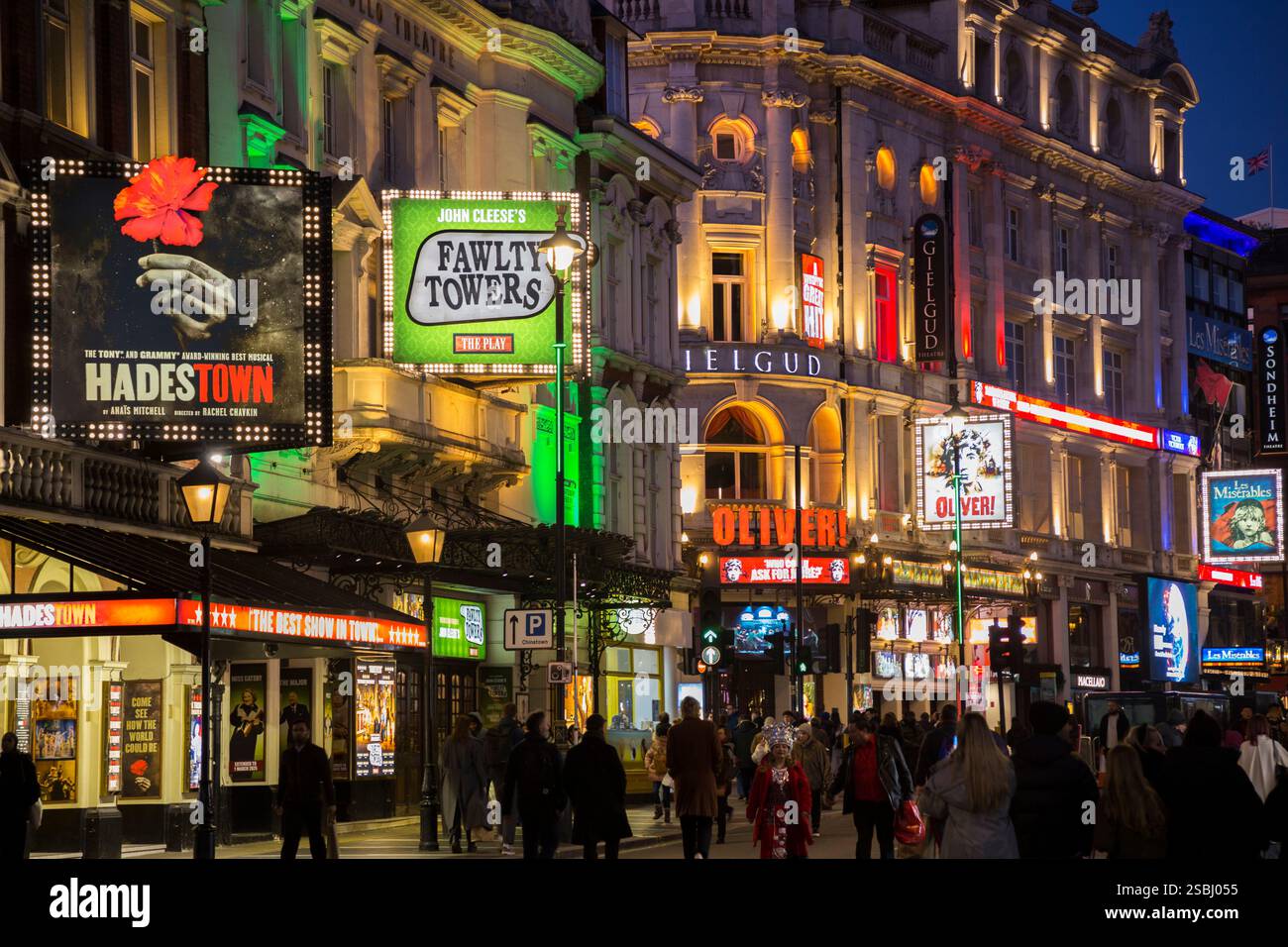 West End theatre land / theatres on a clear evening / night & play signs for plays advertising productions such as Hades Town, and Fawlty Towers by John Cleese, with beautiful neon type colour lighting creating atmosphere and excitement for theatregoers. Shaftesbury Avenue. London. UK. (143) Stock Photo