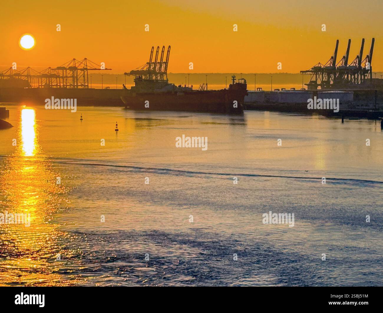 Le Havre, France, Europe - 16 January 2025: Silhouette of container cranes and a ship in the port of Le Havre at sunrise. - Smartphone Captured Stock Image