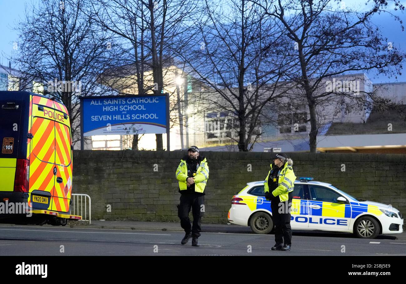 Police officers outside All Saints Catholic High School, on Granville