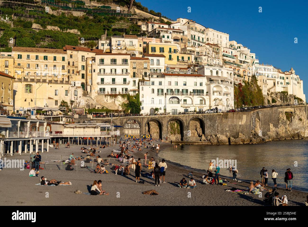 Tourists on the beach in off-peak season at the town of Amalfi on the ...