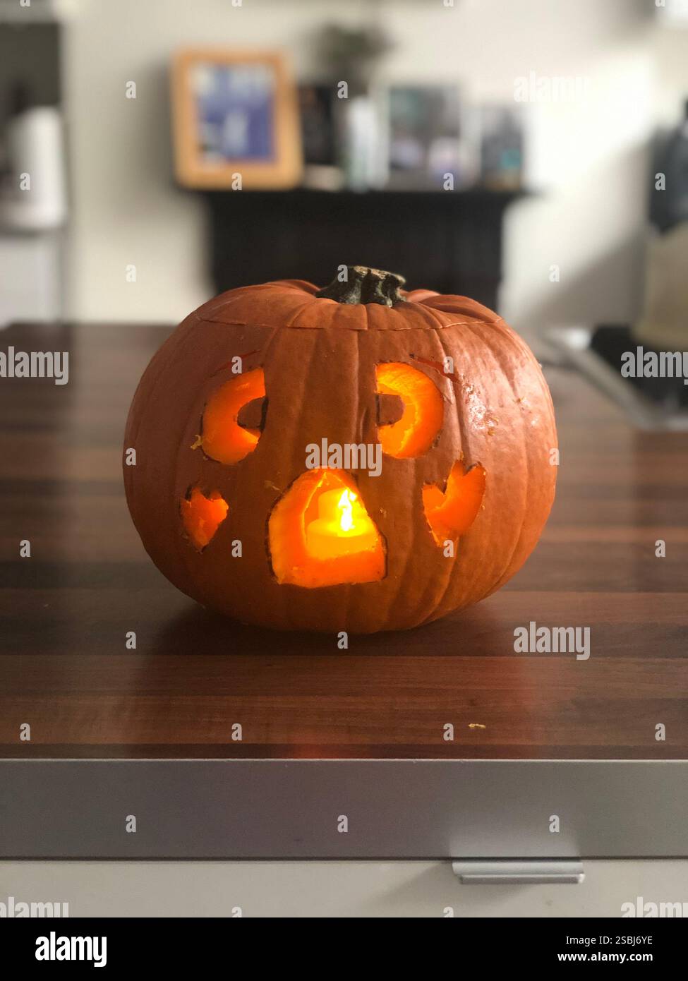 Home-made carved Halloween pumpkin on a kitchen counter - Smartphone Captured Stock Image