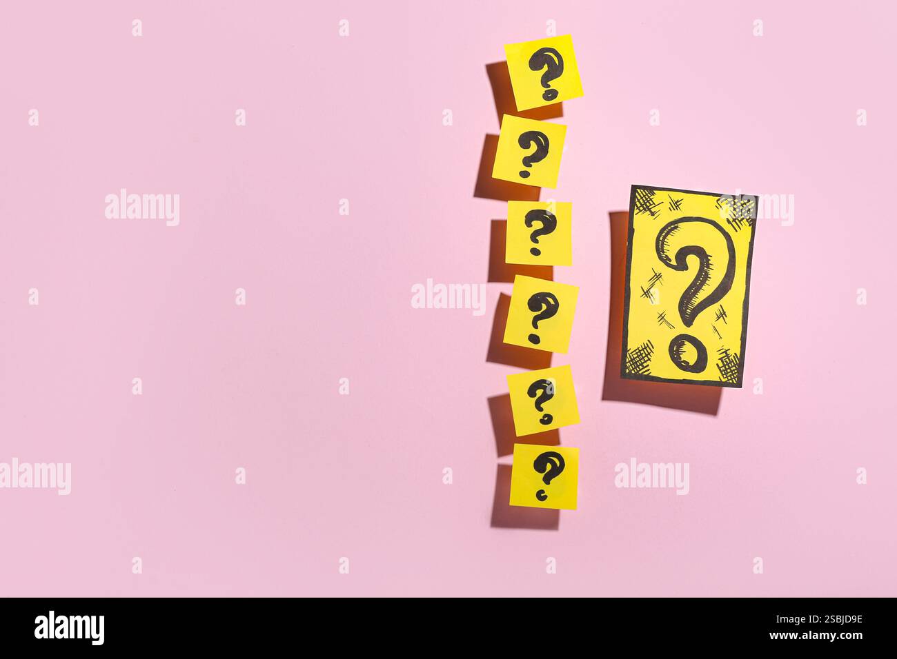 Quiz card with question marks on pink background Stock Photo