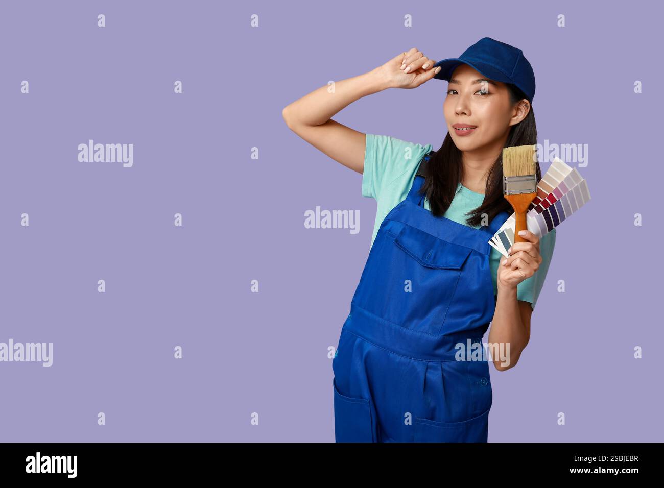 Female Asian painter with brush and paint color palettes on purple ...