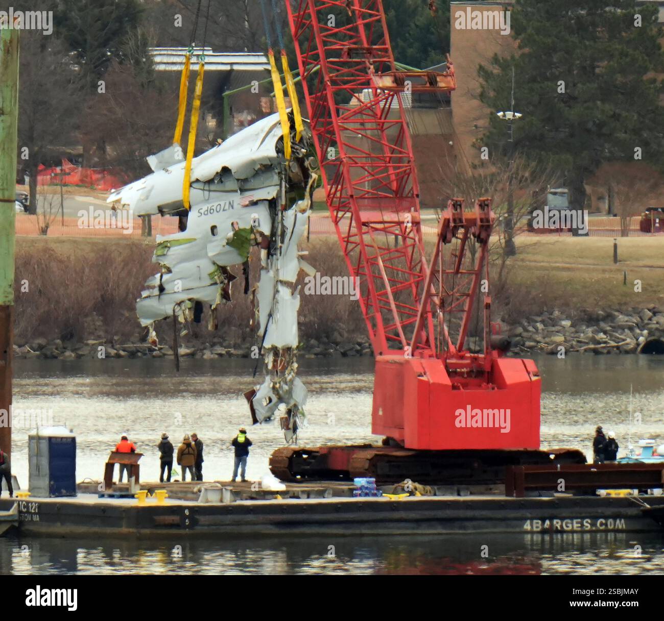 Salavage crews work on the Potomac River recovering wreckage from a ...