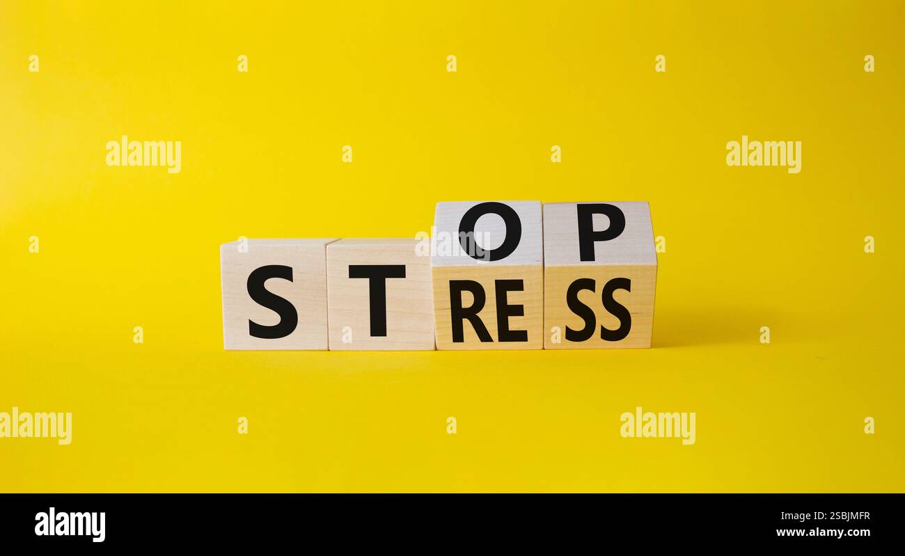 Stop and Stress symbol. Turned wooden cubes with words Stress and Stop ...
