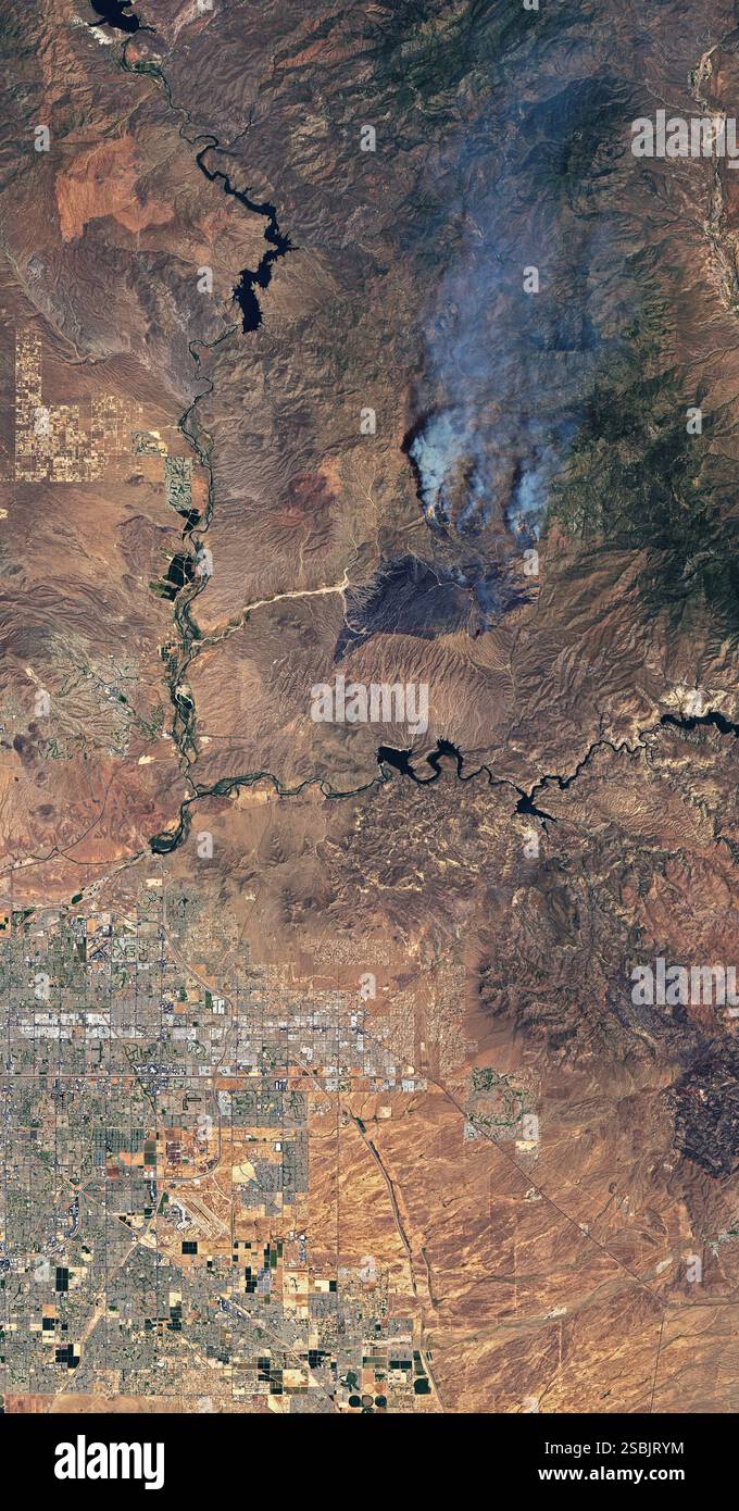 On the afternoon of June 13, 2020, a vehicle fire northeast of Phoenix, Arizona ignited nearby brush and grass. By June 16, nearly 65,000 acres (100 square miles) had burned. The fire was not fully contained until July 6, 2020. It burned a total of 193,455 acres (over 300 square miles). This Landsat 8 satellite image shows the Bush Fire burn scar and some active fire fronts as they appeared on June 14, 2020. Stock Photo