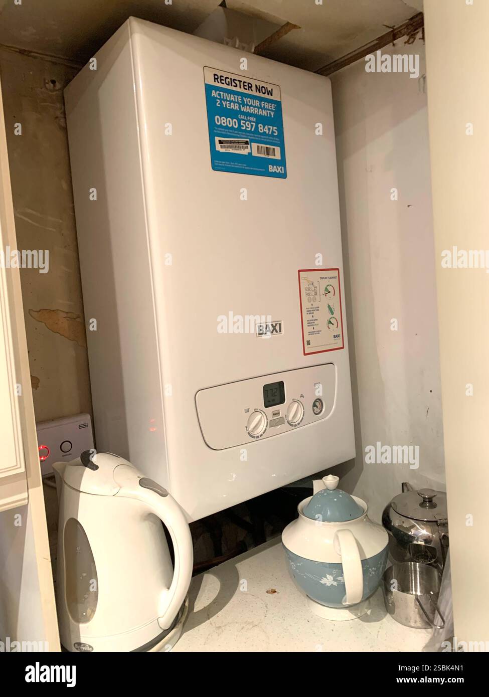 Boiler heating heater kettle tea pot sign signs dial dials socket boiler heat water heater system new cupboard set fit fitted testing shelf shelving - Smartphone Captured Stock Image