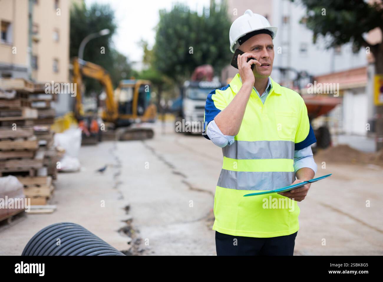 Engineer having telephone conversation in construction area Stock Photo ...