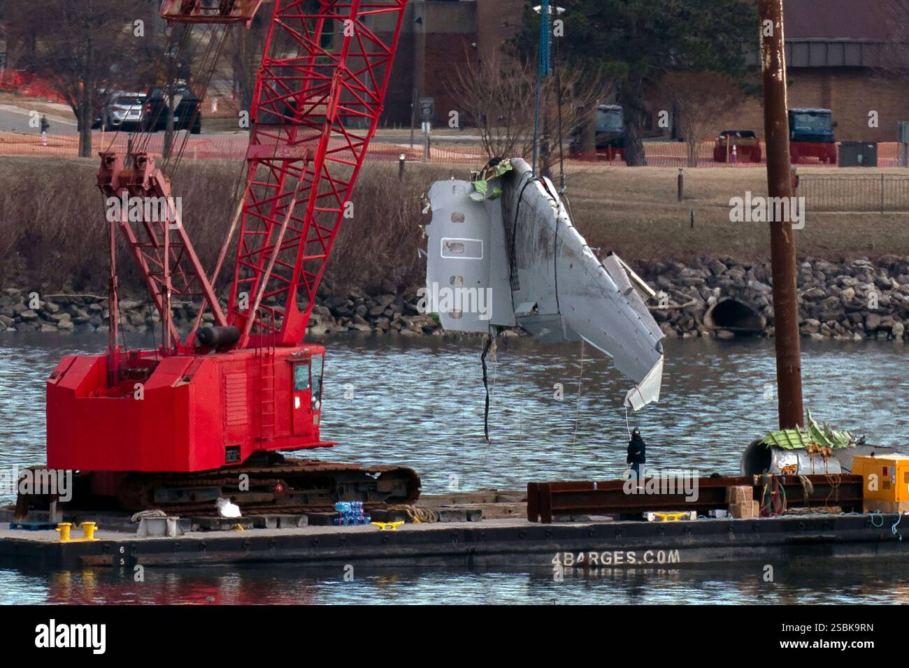 Rescue and salvage crews pull up airplane wreckage of an American ...