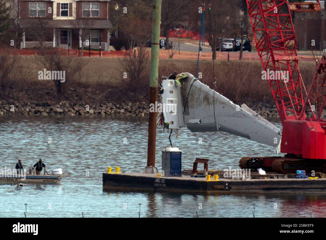 Rescue and salvage crews pull up airplane wreckage of an American ...