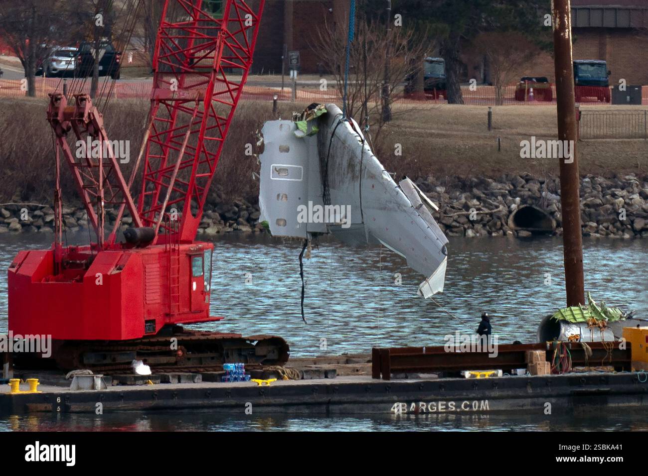 Rescue and salvage crews pull up airplane wreckage of an American ...