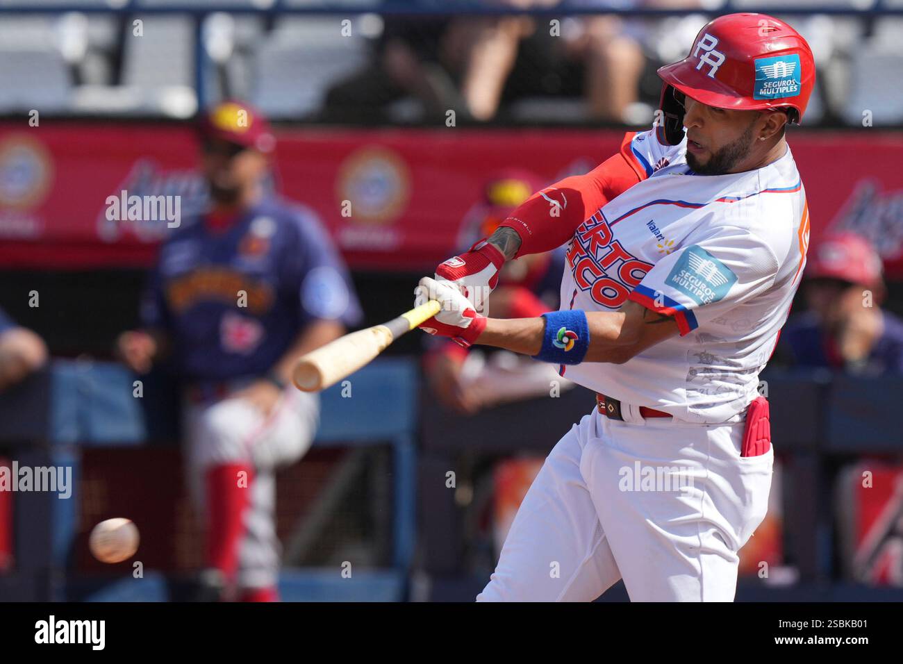 Puerto Rico's Eddie Rosario hits a single against Venezuela during a