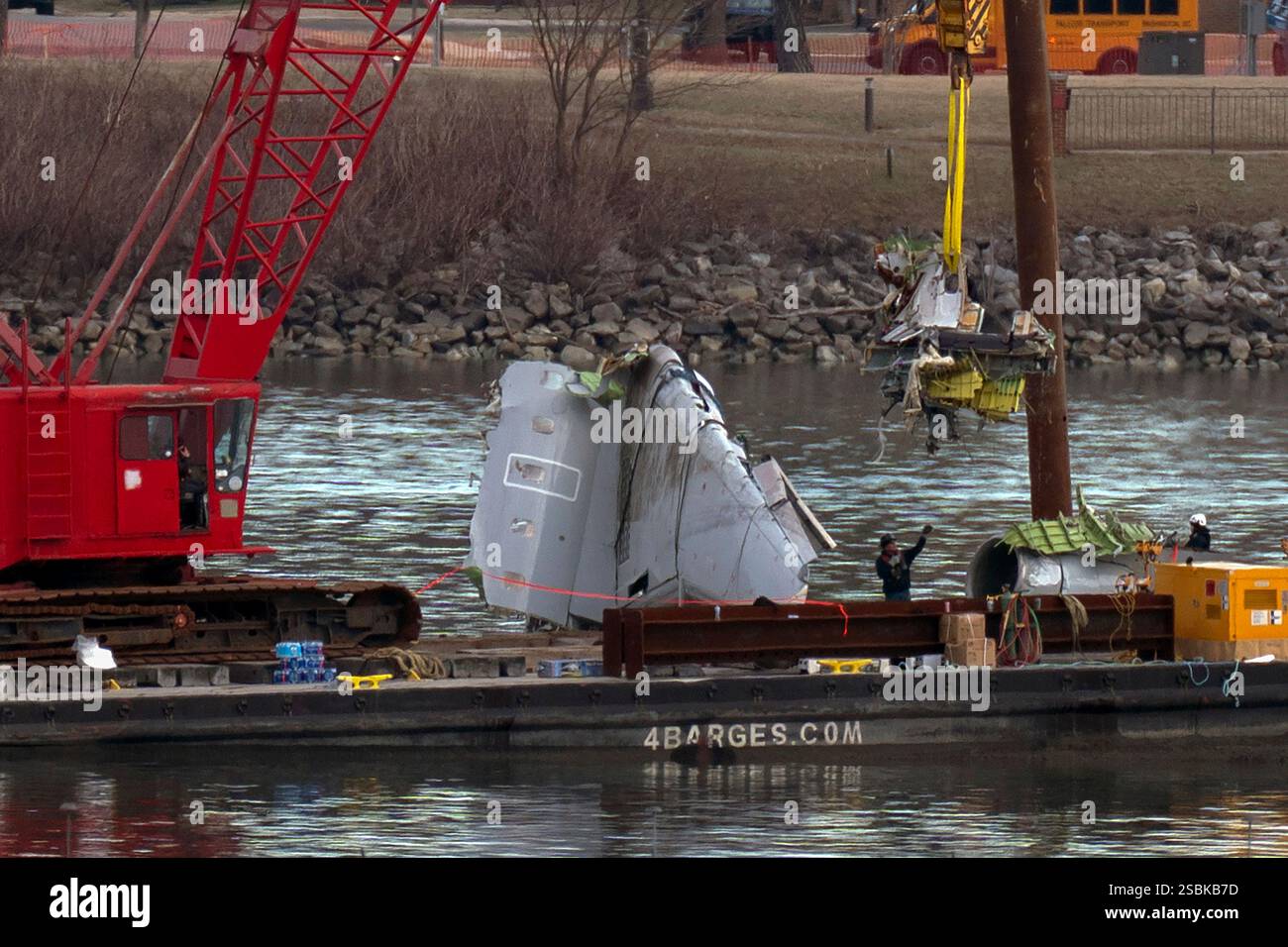 Rescue and salvage crews pull up airplane wreckage from an American ...