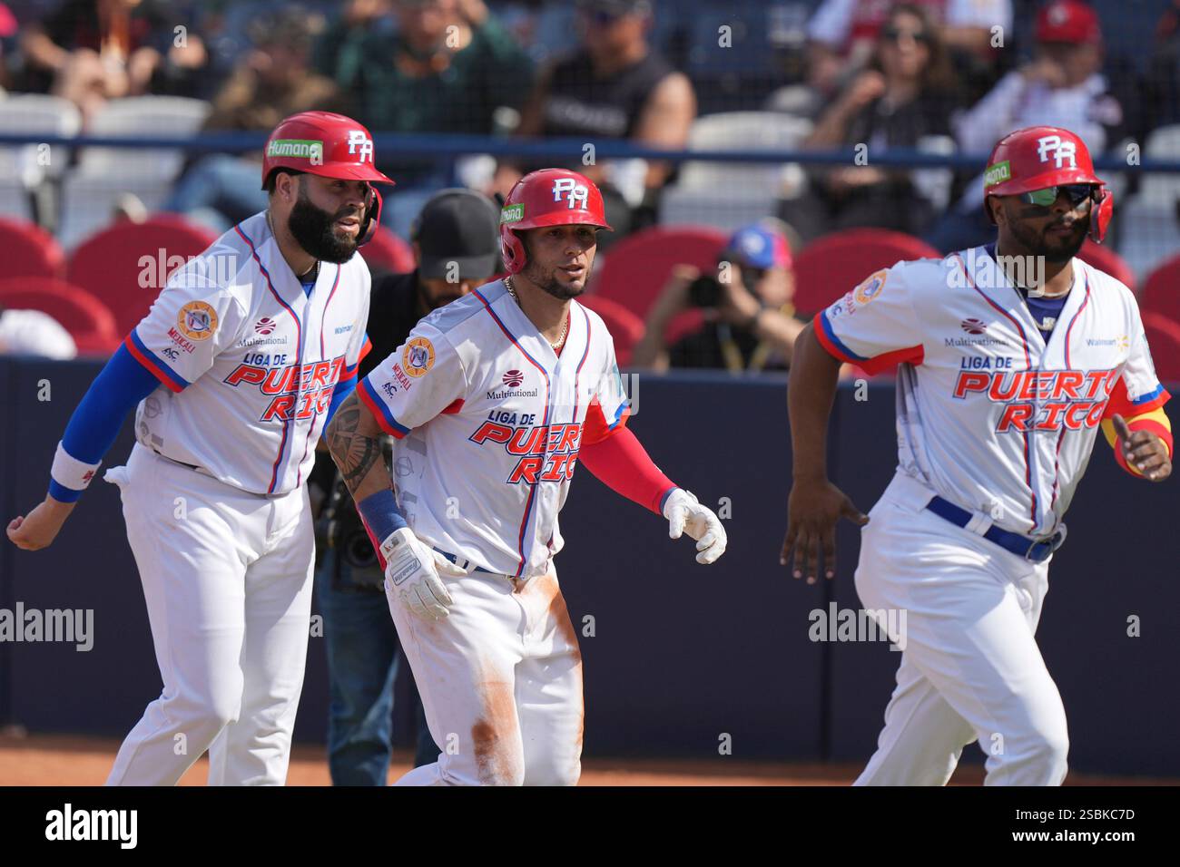 Puerto Rico's Danny Ortiz, center, celebrates scoring against Venezuela