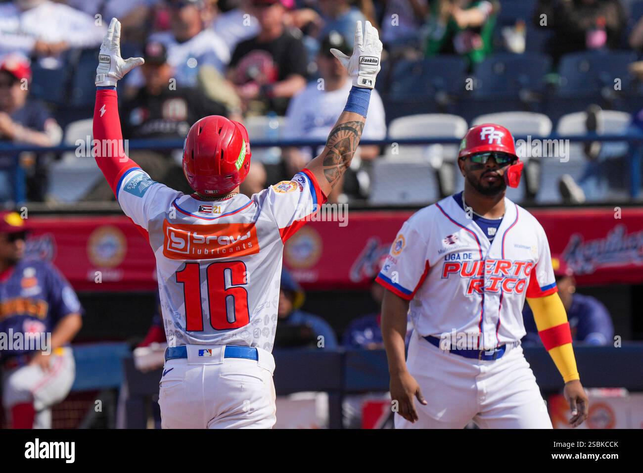Puerto Rico's Danny Ortiz, left, celebrates scoring against Venezuela