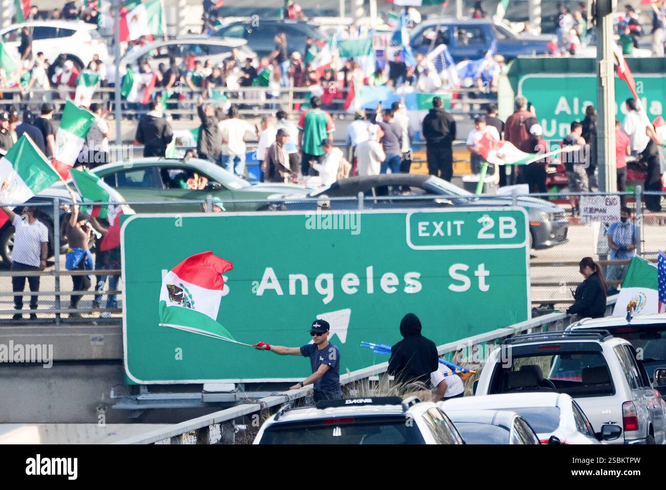 Demonstrators wave flags during a protest demanding immigration reform ...