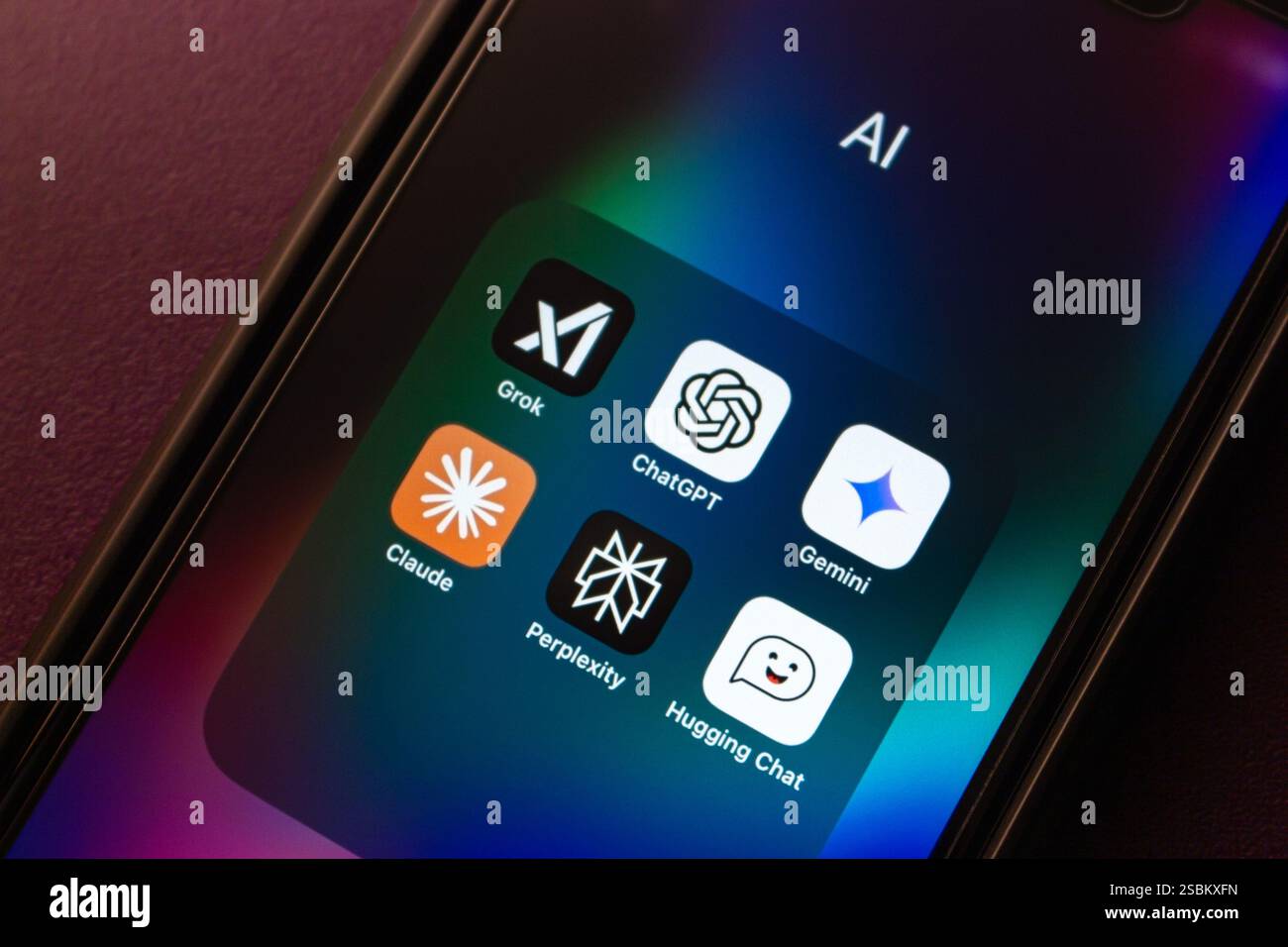 Grok AI, ChatGPT, Google Gemini, Claude, Perplexity, and Hugging Chat apps are shown on an iPhone. Modern generative AI chatbot service concept image. Stock Photo