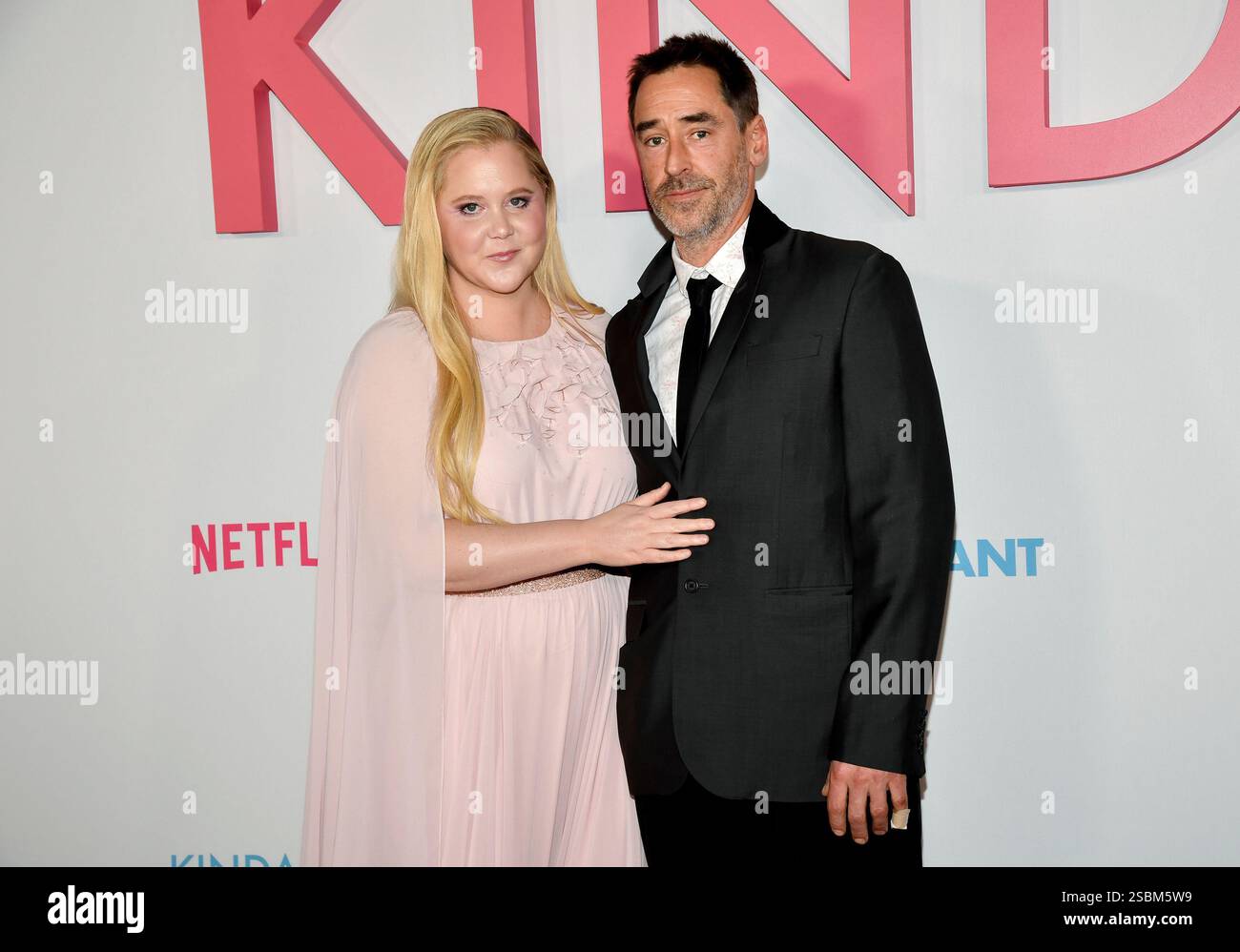 Amy Schumer, left, and husband Chris Fischer attend the premiere of